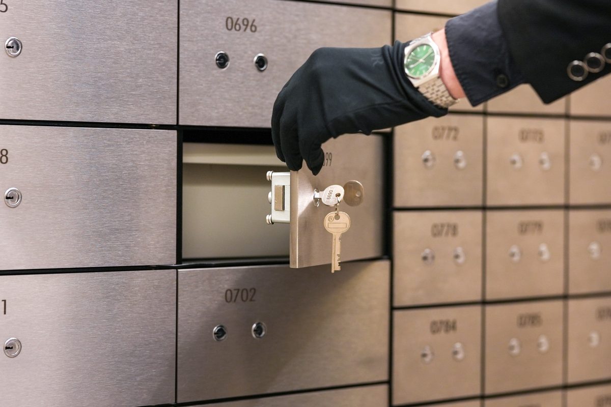 Gloved attendant retrieving keys from an Amanat Vaults safe deposit box